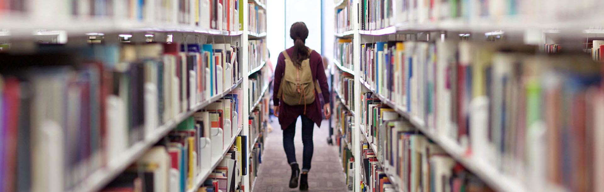 Student walking through Library